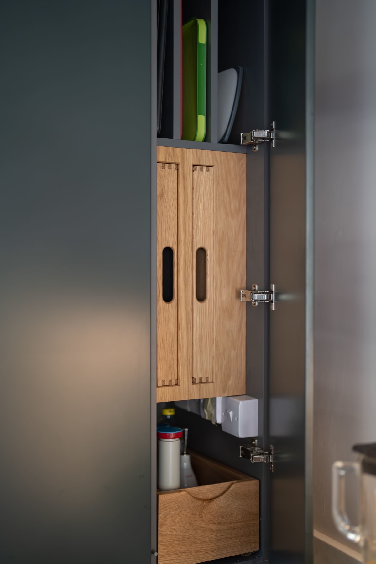 A larder with built in oak trays and chopping boards