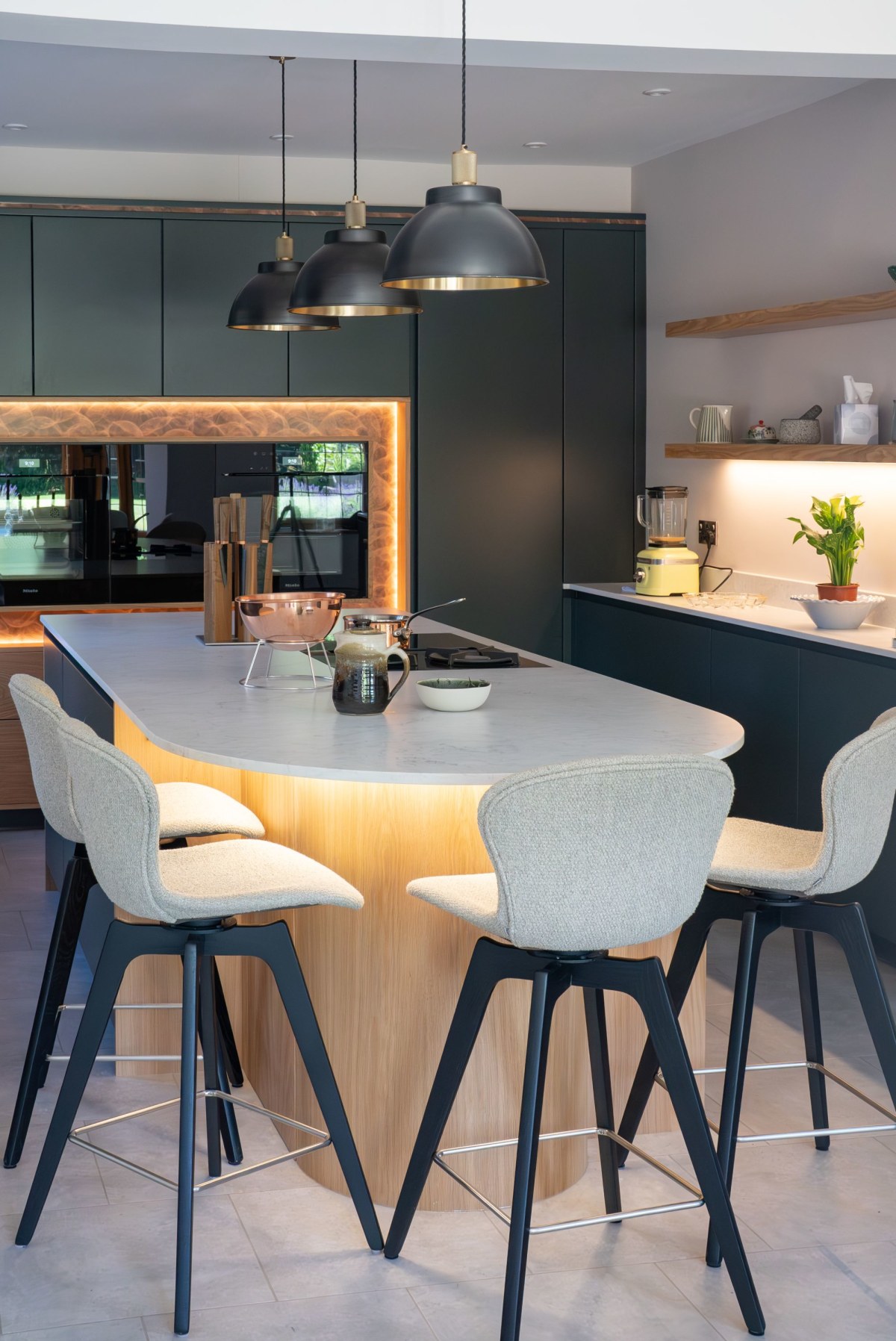 four white stools around a kitchen island with white quartz worktop