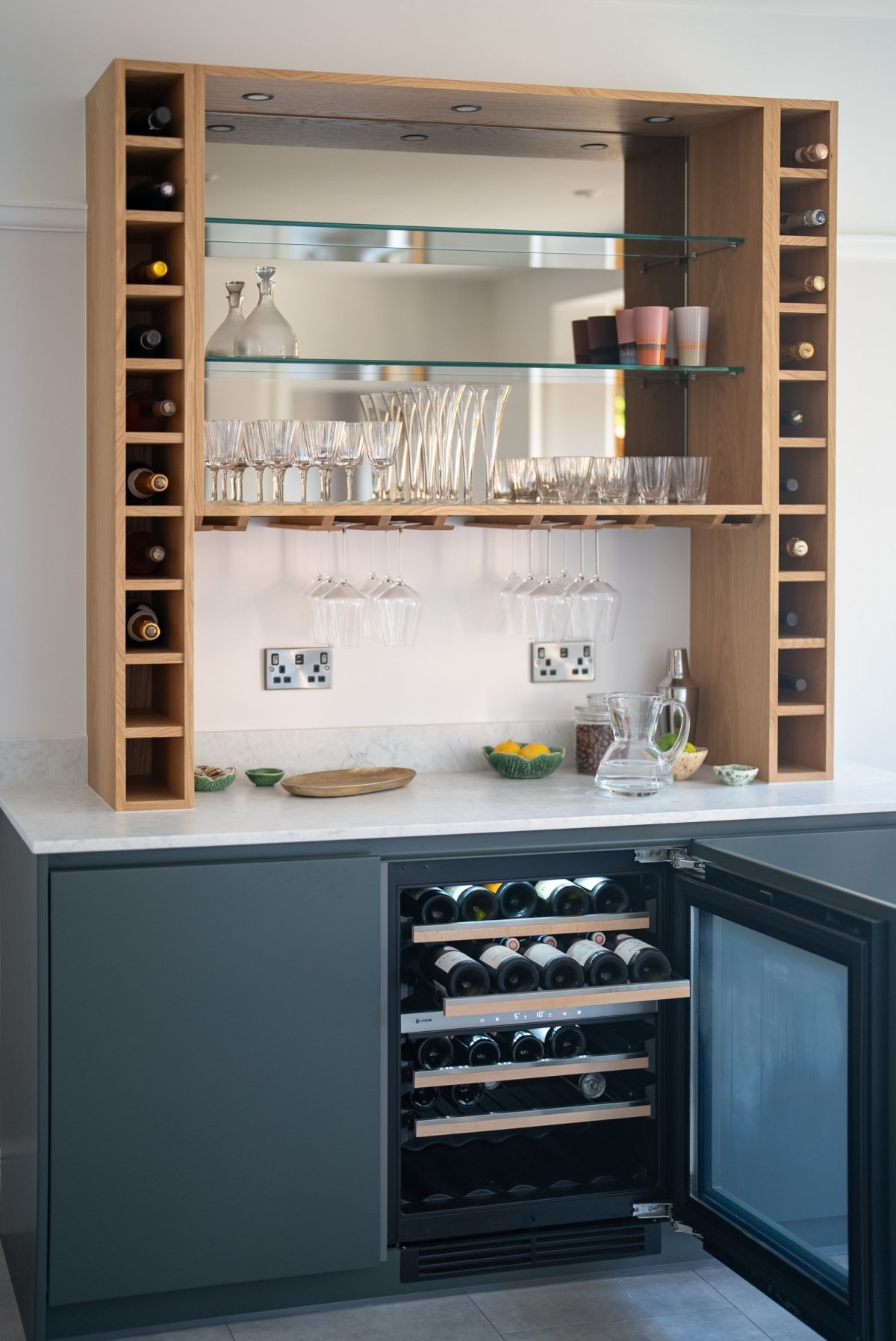 a drinks bar with wine conditioning unit with door open