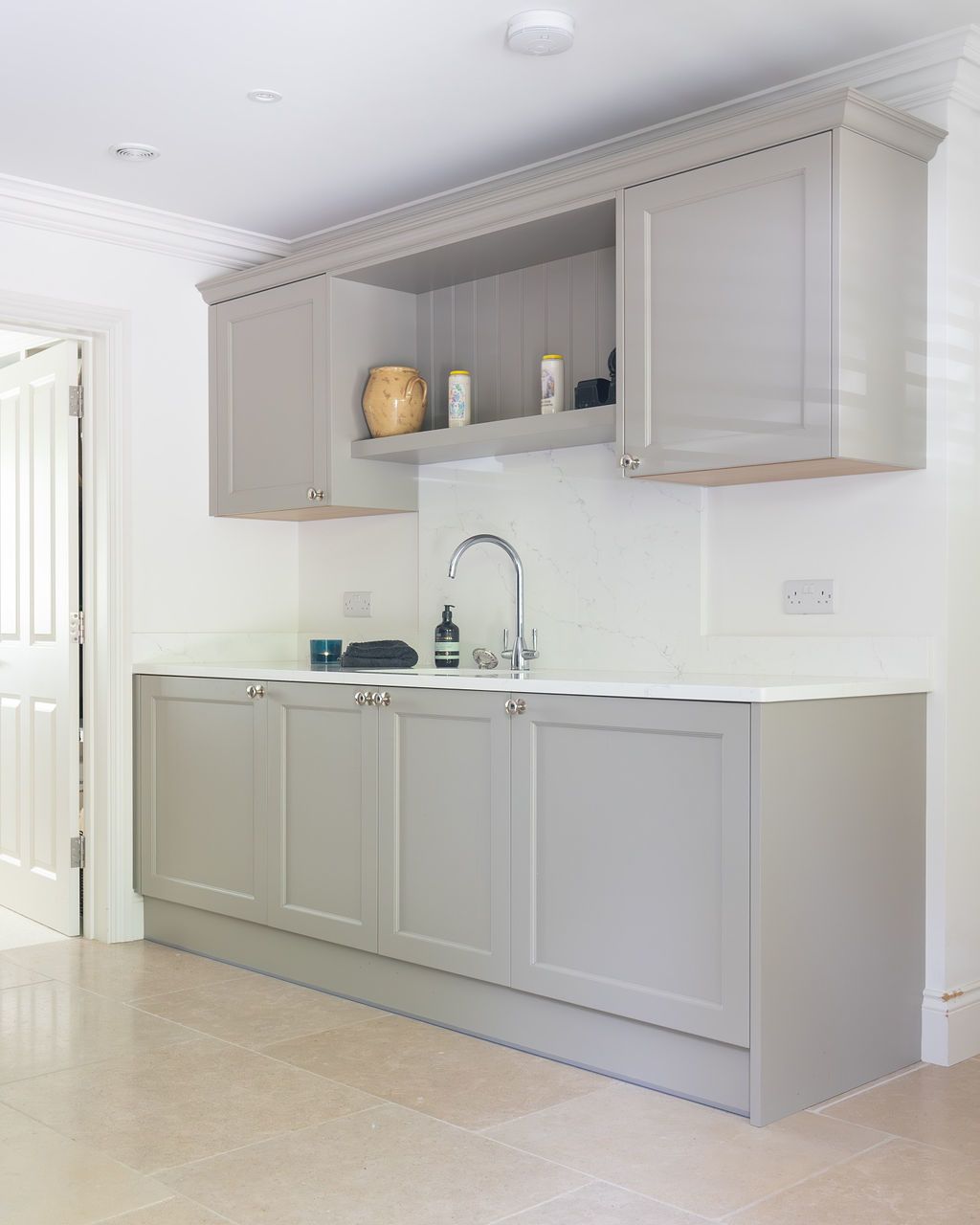 a boot room with cupboard and wall cupboards