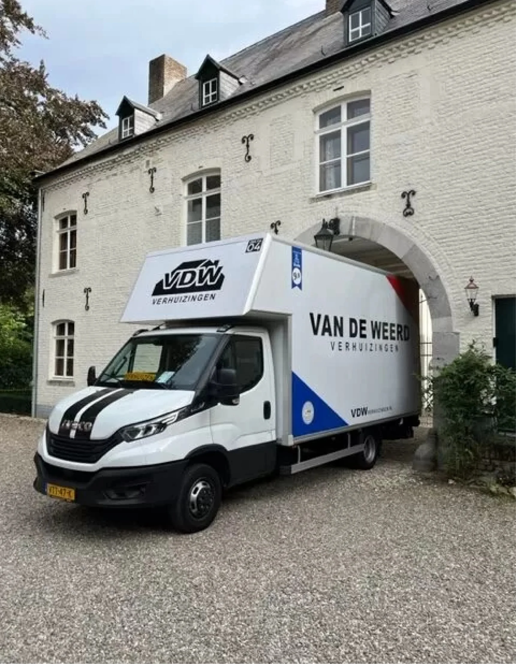 VAN DE WEERD removals van outside a manor house
