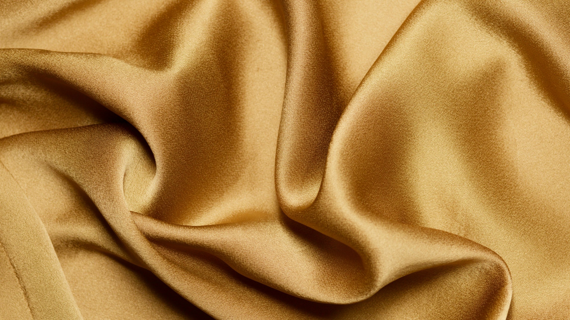 Soft folds of gold silk satin