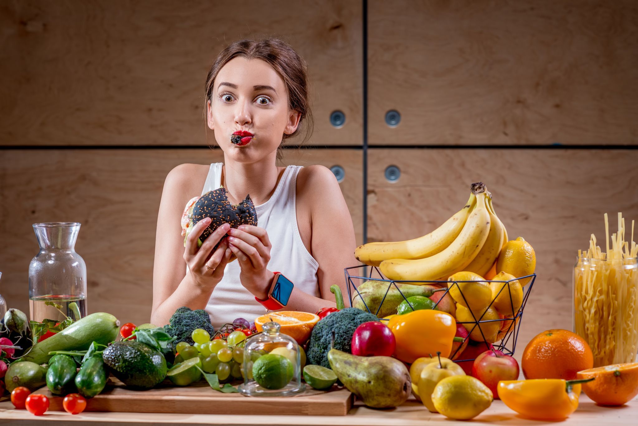 Vegan woman eating a lot of plant foods