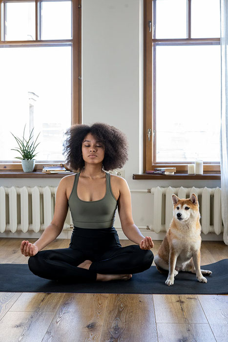 woman meditating with her dog