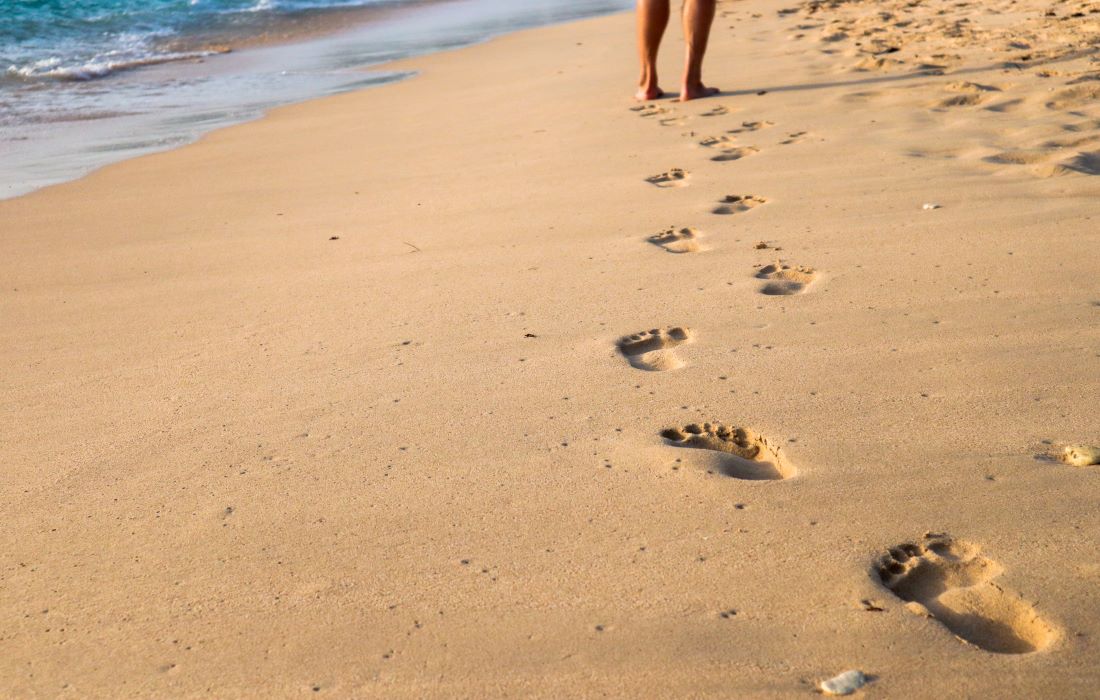 walking on the beach leaving footprints