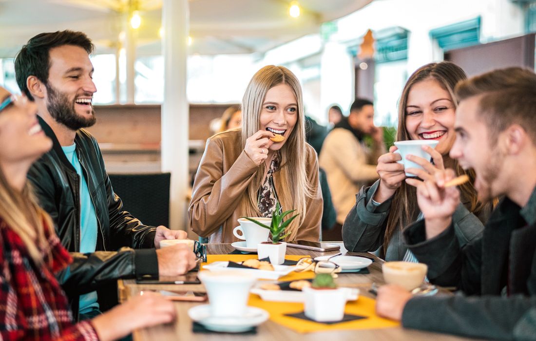 friends laughing at cafe