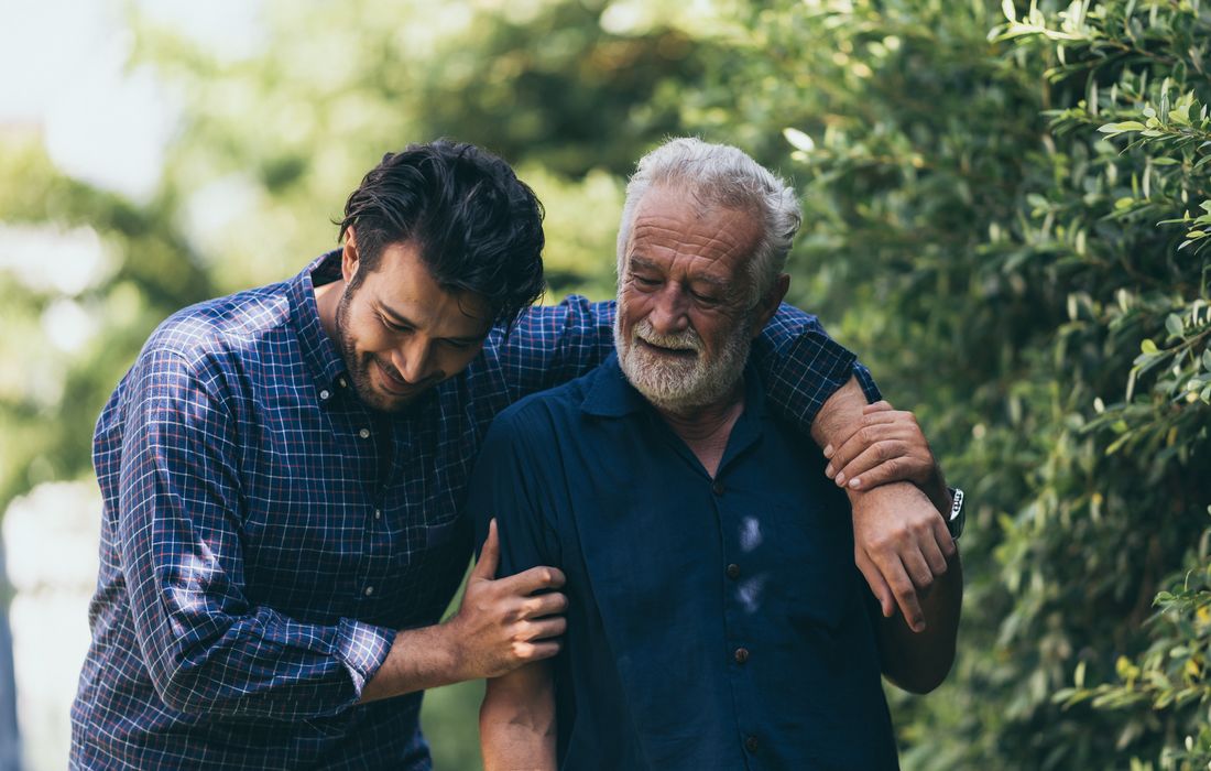 young man helping older man