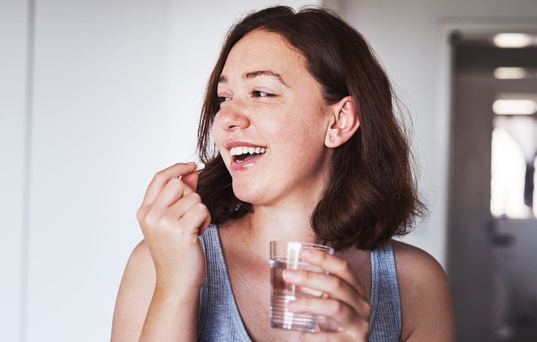 woman taking supplement