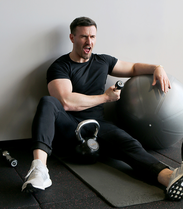 man grabbing dumbbell