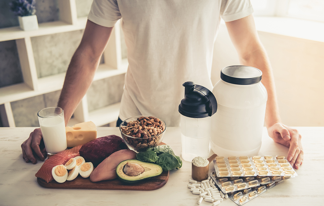 man in kitchen cooking balanced meal protein