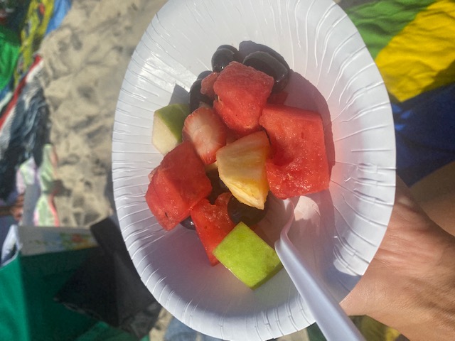fruit salad in a plate on the beach