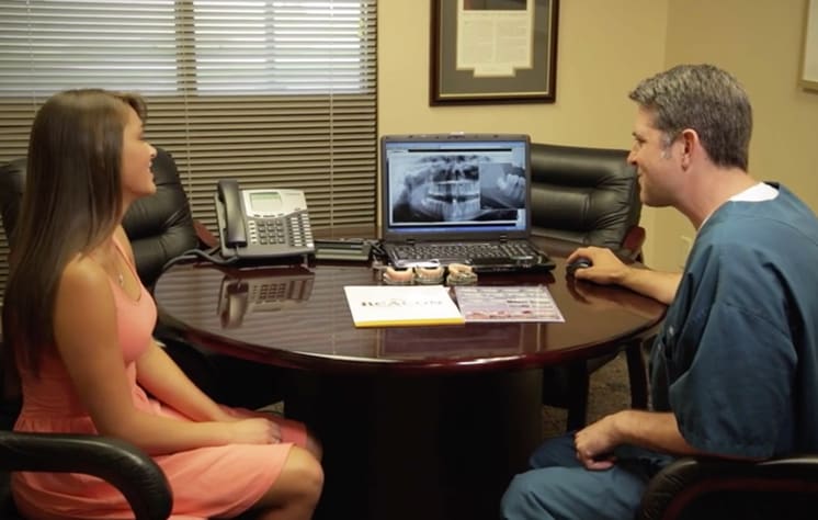 Dr. Lieblick talking to patient and looking at x-ray