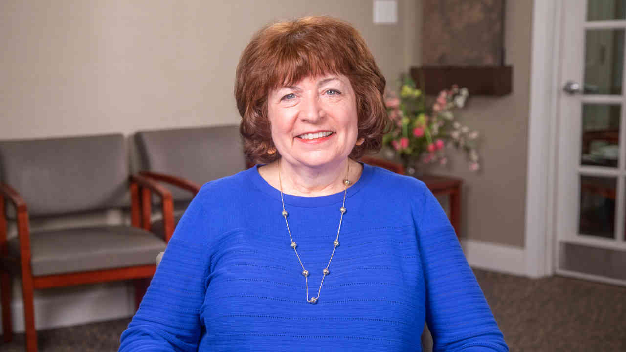 portrait image of cathy after dental implants