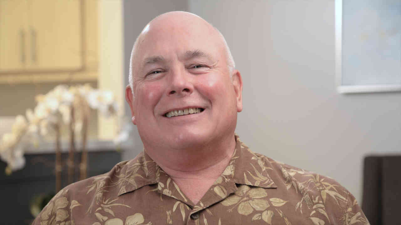 portrait image of John after Dental Implants