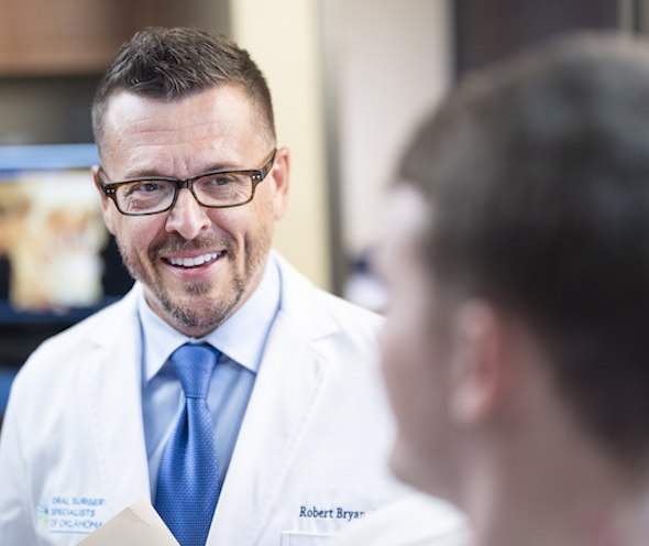 Dr. Bryan shaking hands with a patient