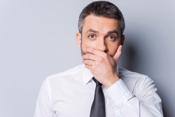 A man looking shocked, because he's chipped his teeth!