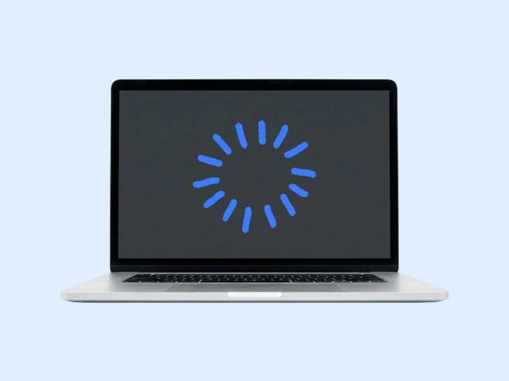 Lap top computer with spinning icon on the screen
