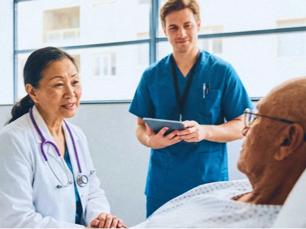 Doctor and nurse bedsite speaking with a patient
