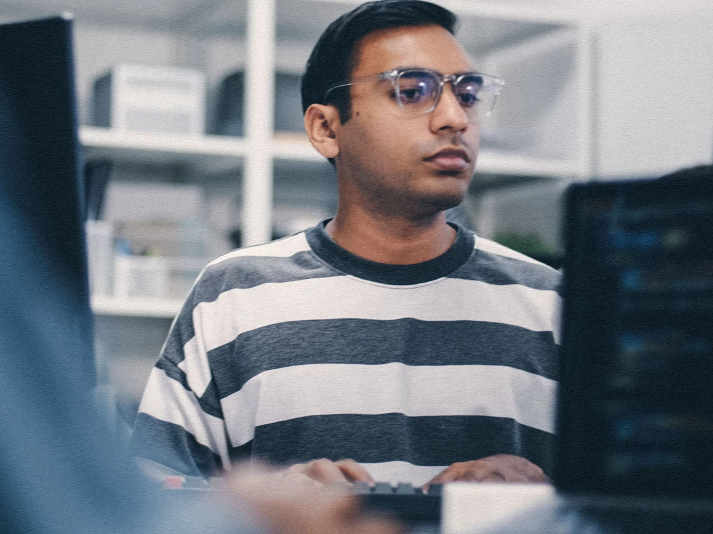 Guy looking at at computer in a pharmacy