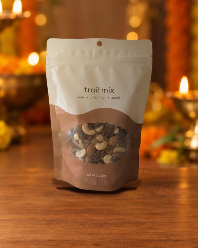 Trail mix pouch, brown · plastic, staged in a diwali glow scene