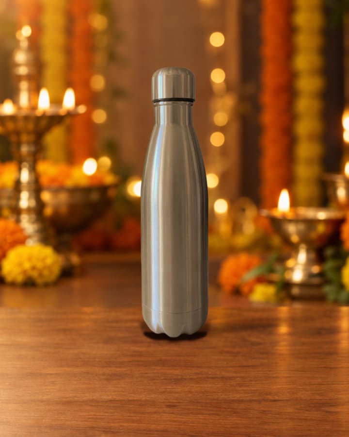 Steel water bottle, silver · stainless steel, staged in a diwali glow scene