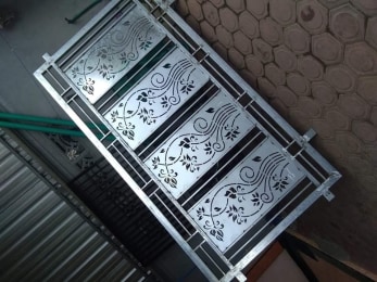Laser-cut window grill with floral panels, ready for dispatch