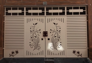 Laser-cut main door with floral scroll panels in cream finish