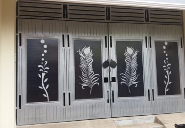 Laser-cut door panel with feather and vine motifs