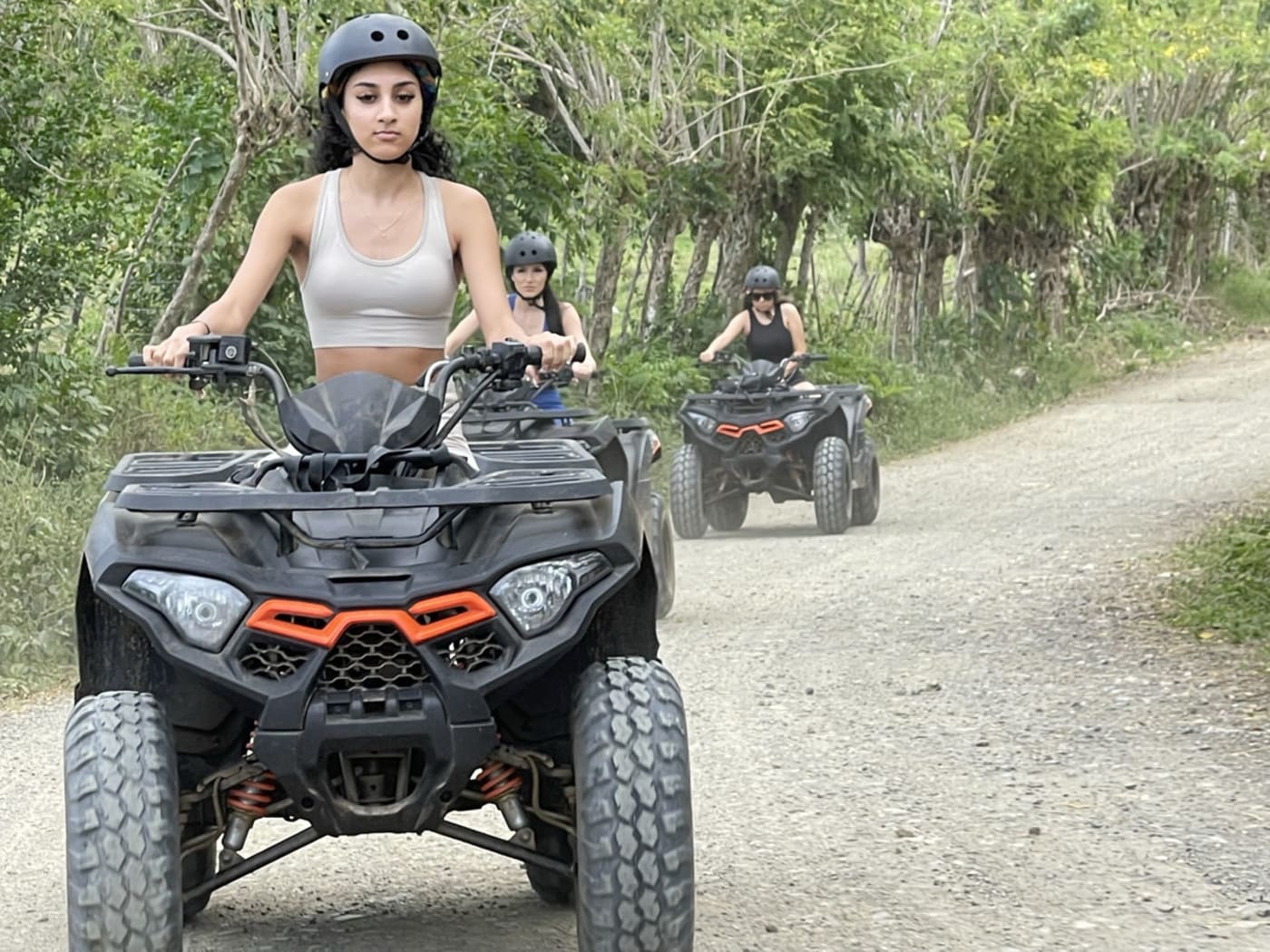 ATV convoy on a muddy trail to Montaña Redonda