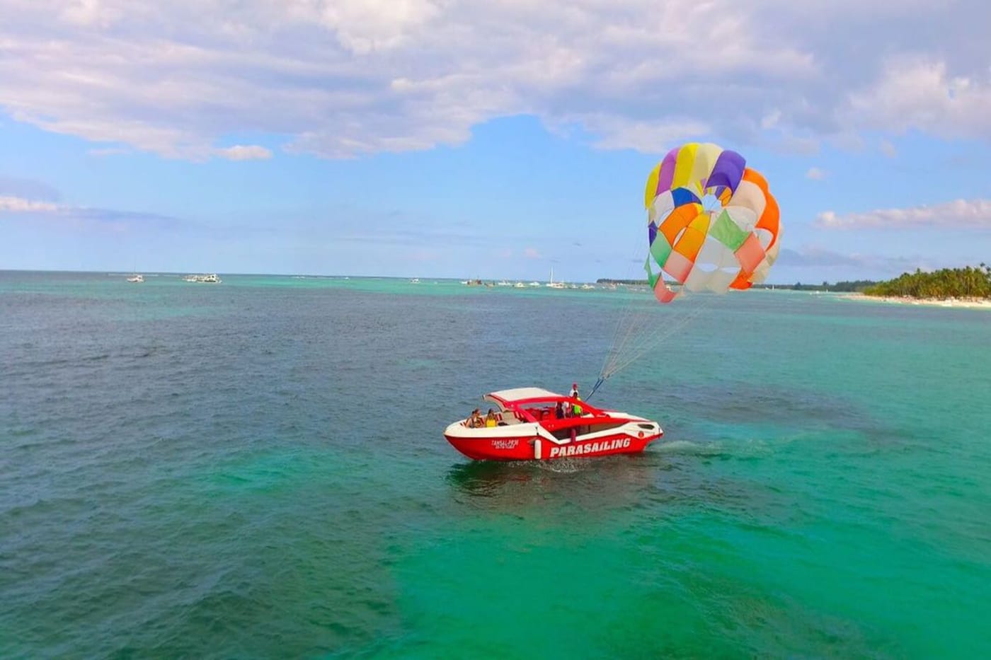 Crew clipping riders into the parasail harness