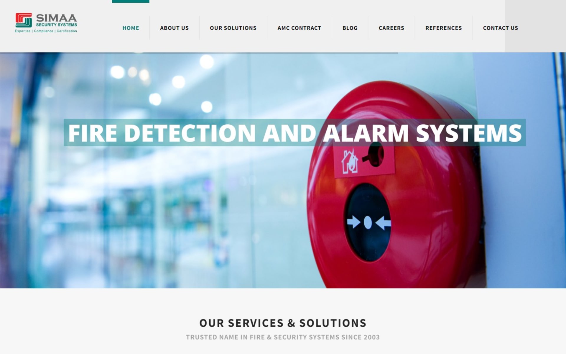 WordPress website for Simaa Security Systems, a Dubai ELV integrator, Homepage: a full-width slider headed Fire detection and alarm systems, under the teal and red header