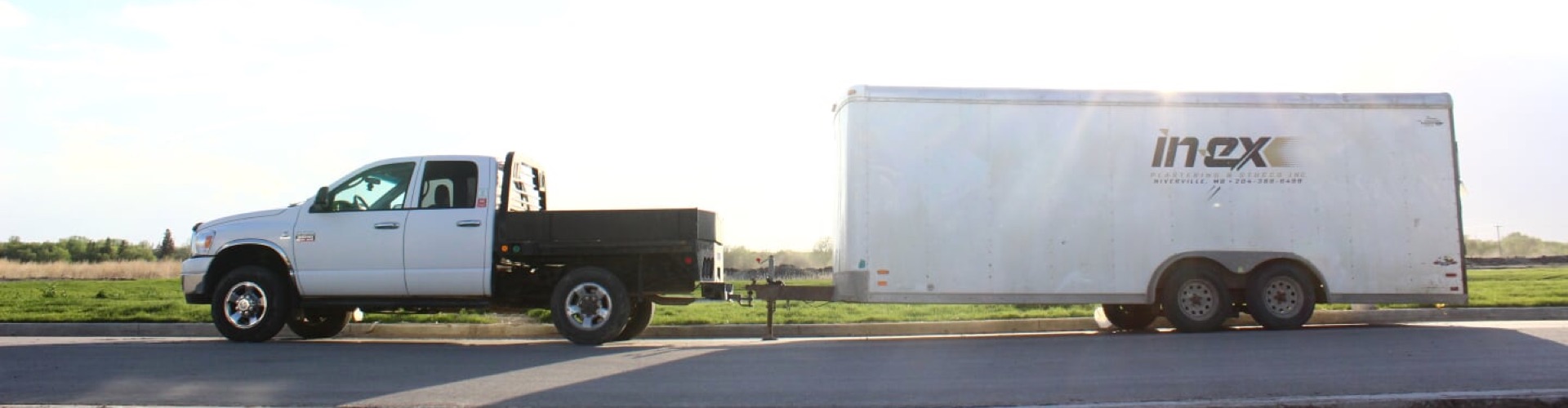 An Inex Plastering truck in front of a sun rise.
