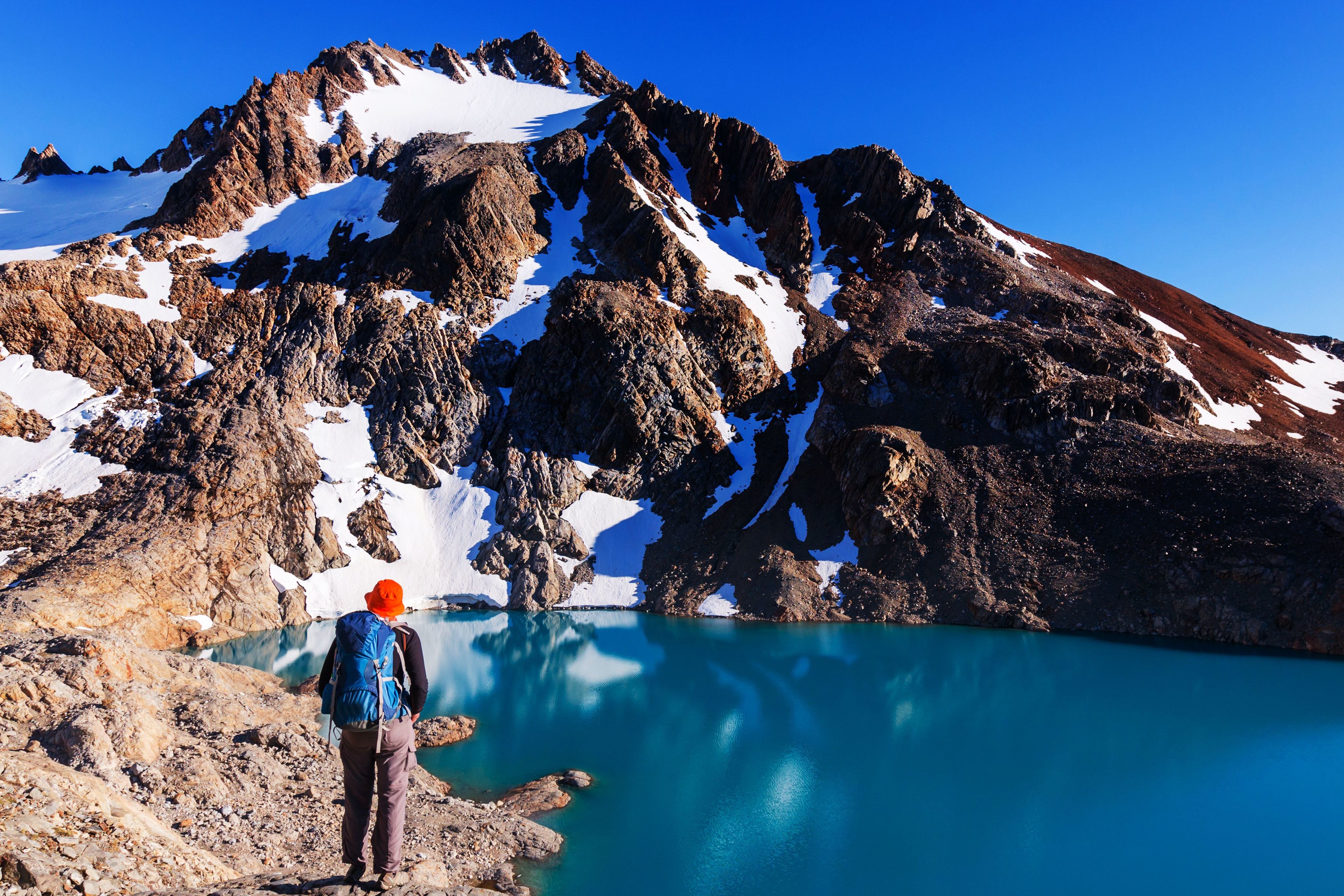 People Trekking Through Patagonia Mountains