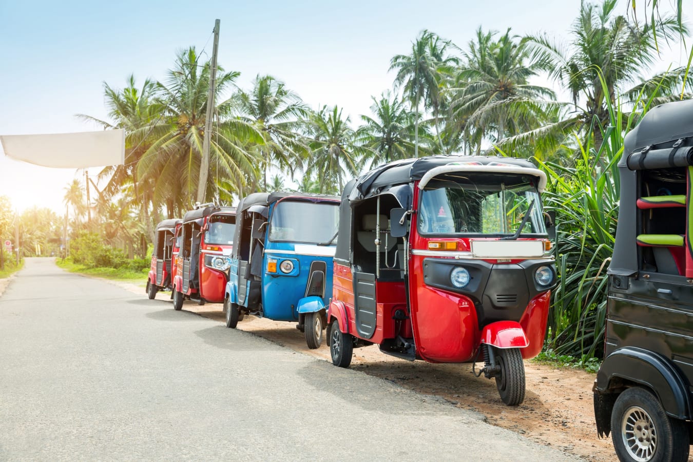 Tuktuks parked along a street in Sri Lanka