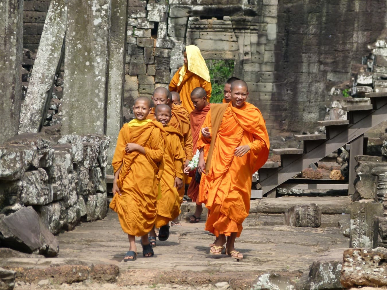 Young Buddhist monks walking through a temple in Siem Reap Cambodia