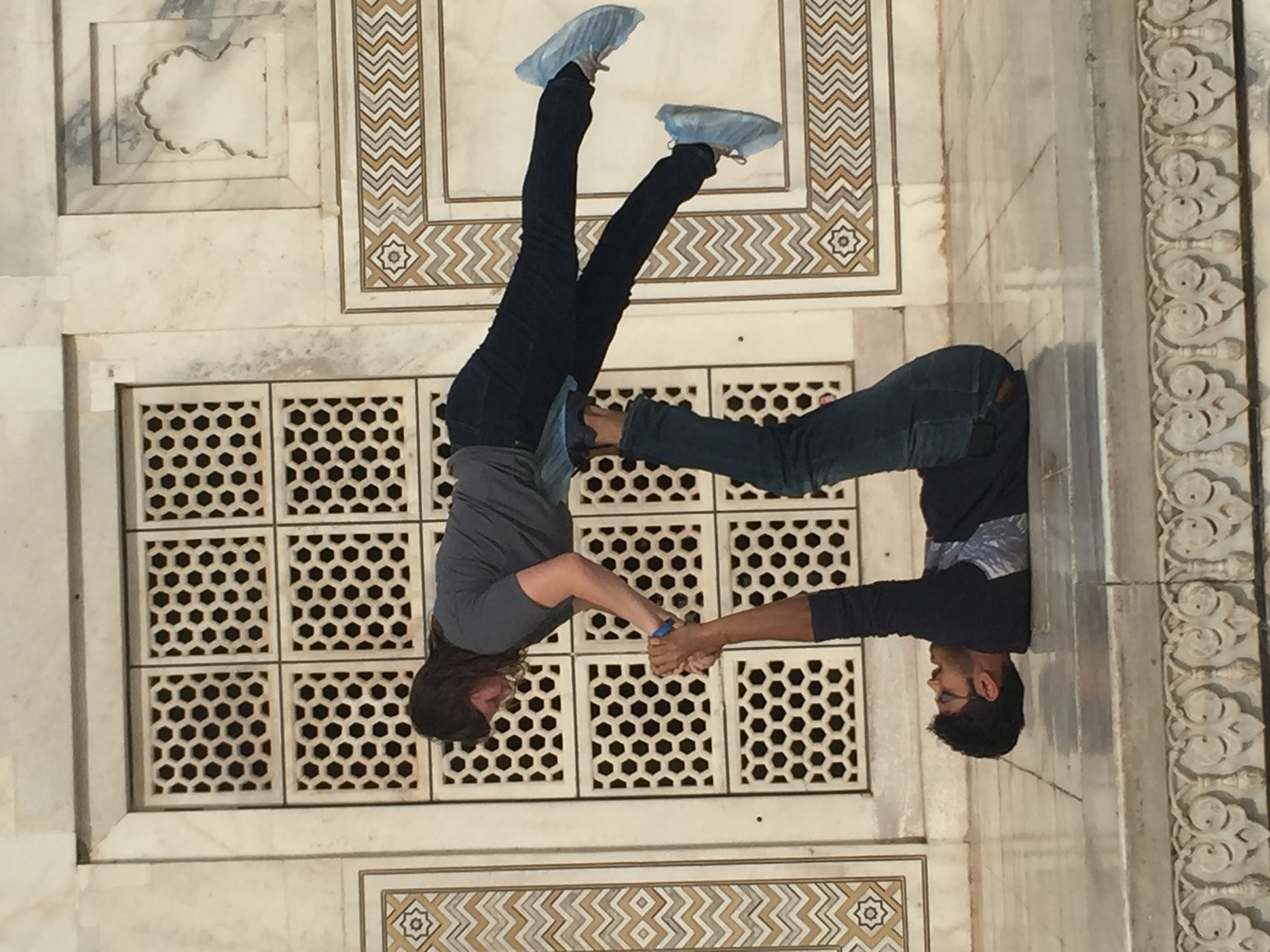 Besteverindiatour guests performing Acro-yoga balance at Taj Mahal.