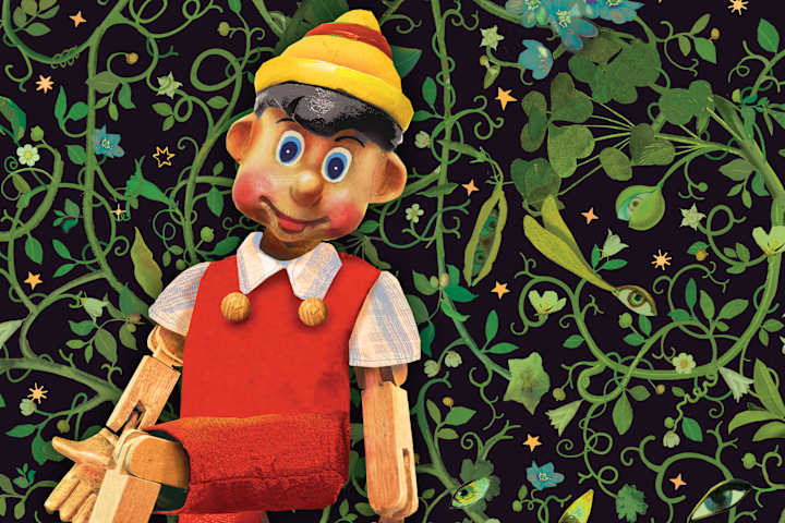 Bilde av tredukken Pinocchio som ser mot kameraet med en grønn natur som bakgrunn.