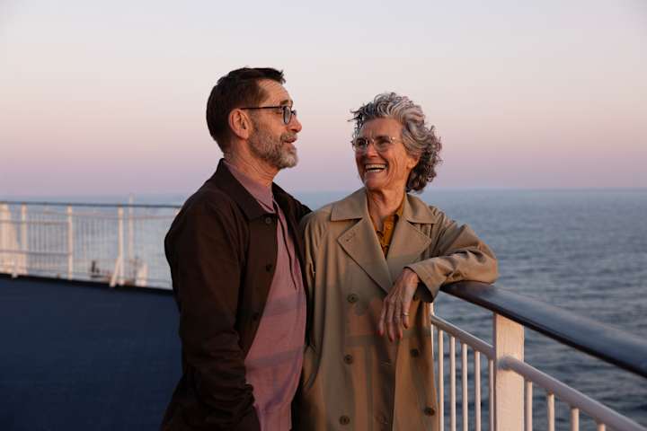 To personer smiler om bord på båt.