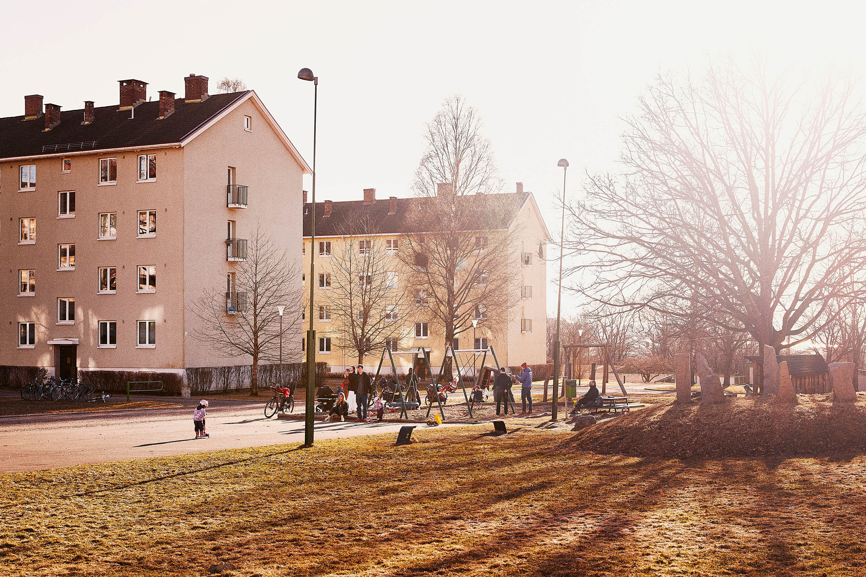 Et bilde av to boligblokker som står ved siden av hverandre. I forkant er det en stor gresslette.