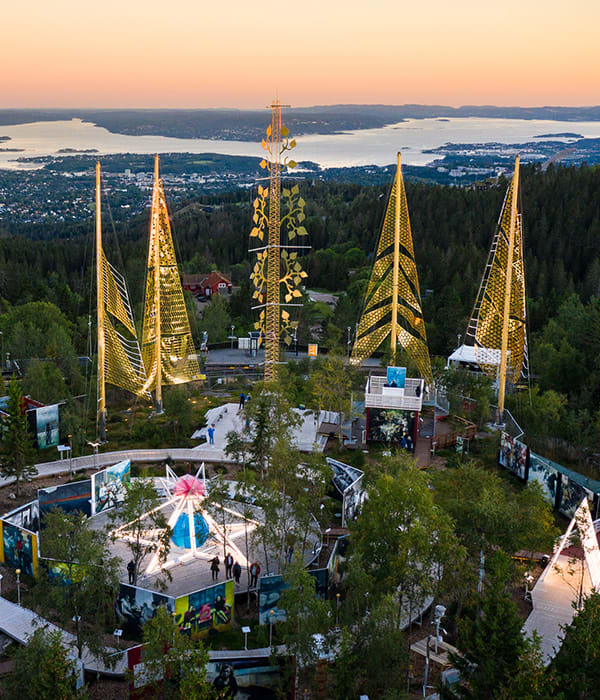 Utsiktsbilde over Roseslottet fra Holmenkollen. Det er solnedgang.