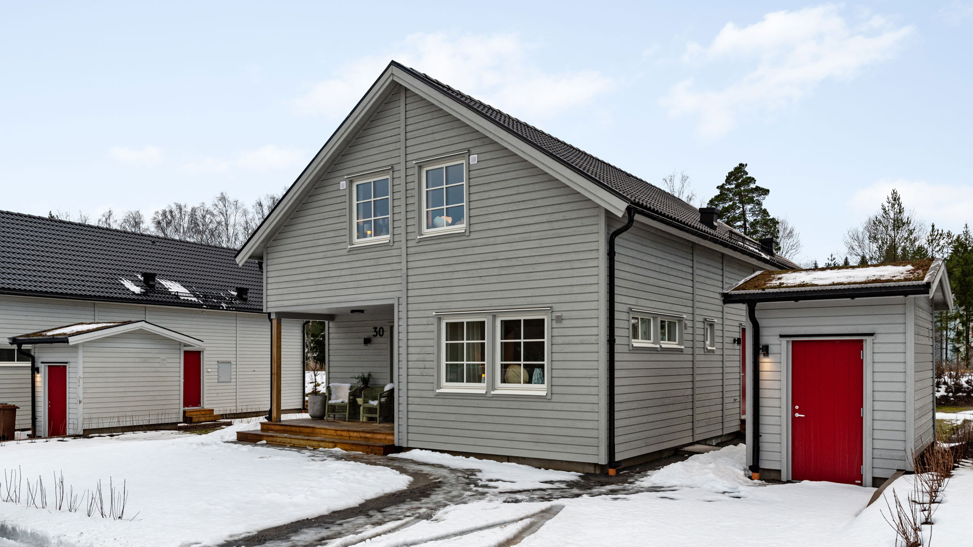 Trähus i grått en snöig dag