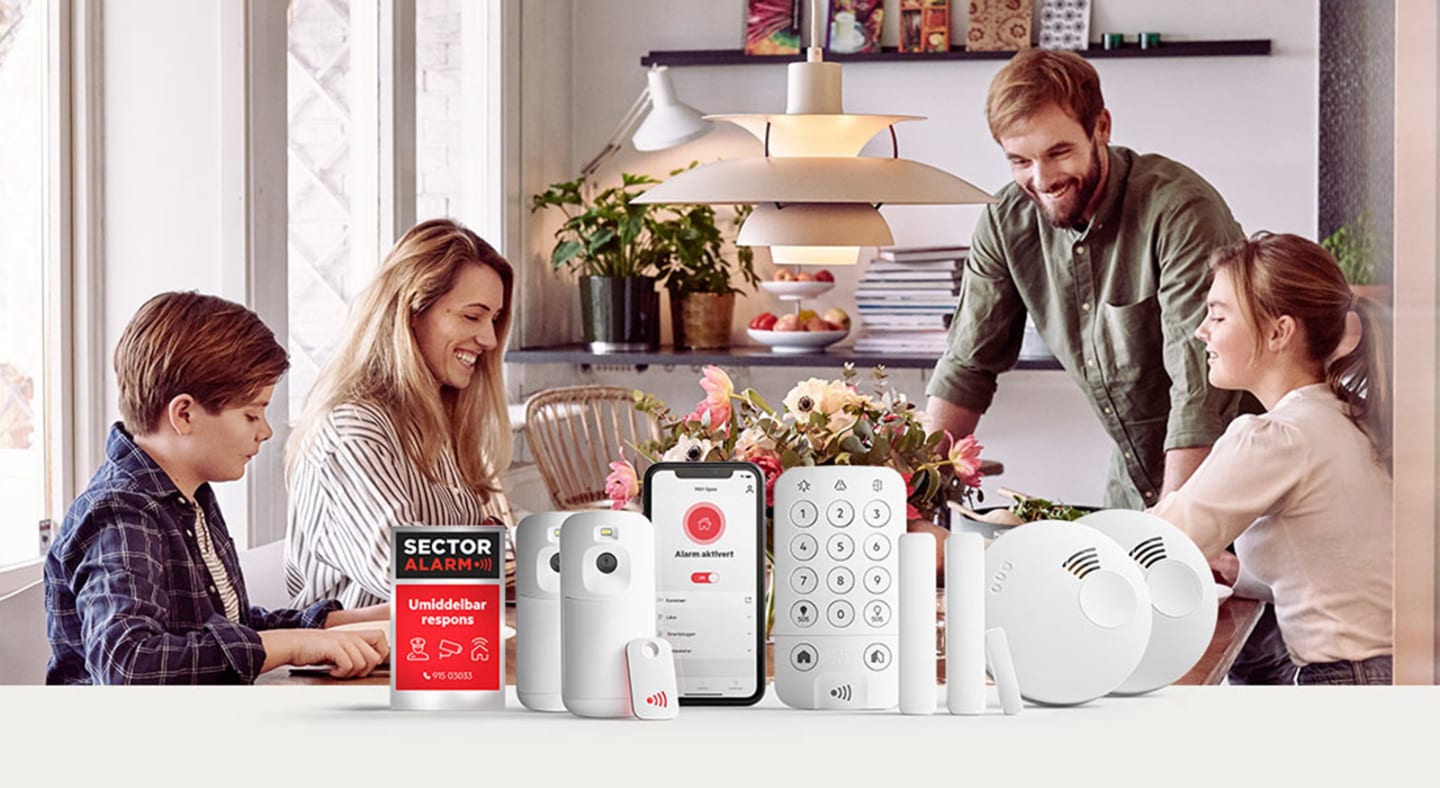 Familie sitter rundt middagsbord med Sector Alarm Produkter