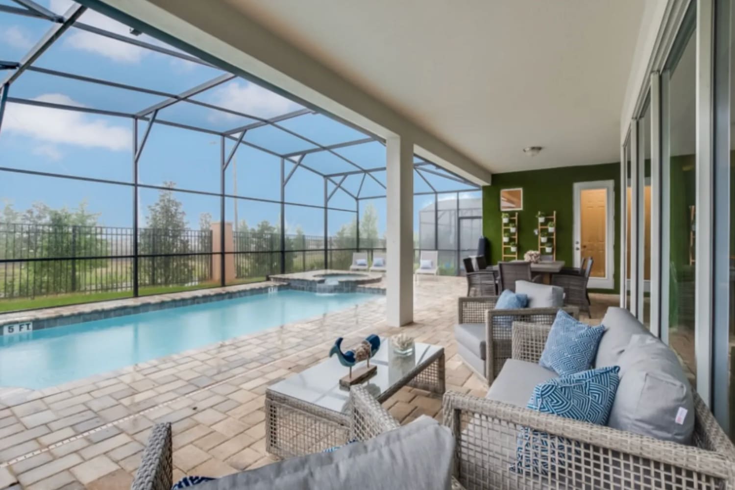 A daytime picture of a private swimming pool and terrace in a villa for large groups at Solara Resort in Florida