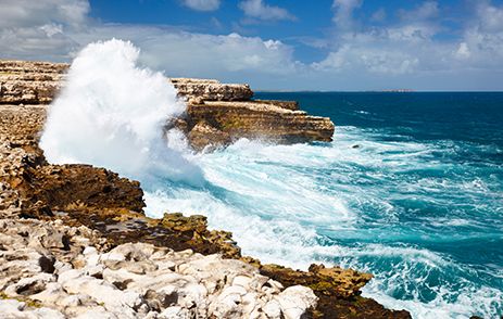 Waves crashing into cliffs in Antigua