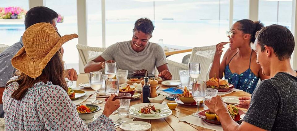 friends eating at Jumby Bay restaurant