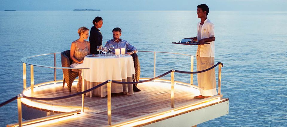 Beautiful alfresco romantic dining couple at Velaa Private Island