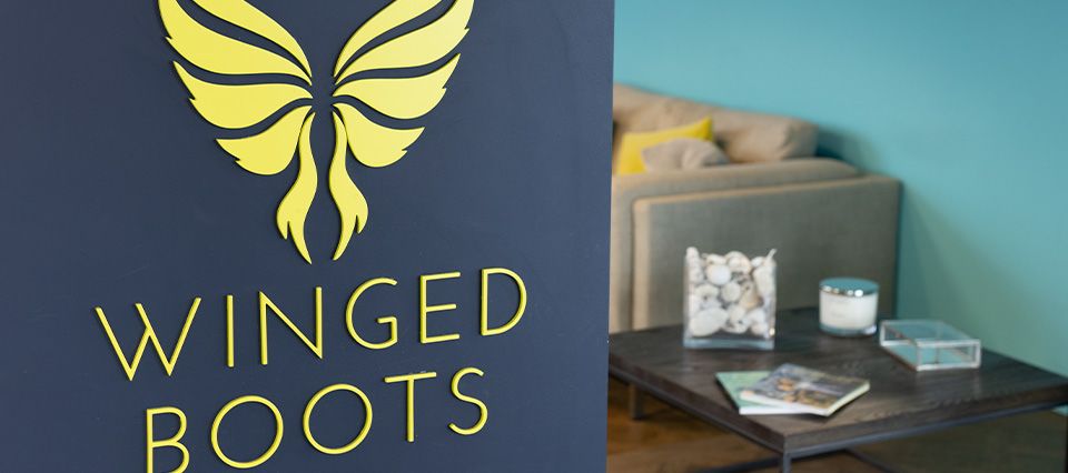 The Winged Boots sign in our head office