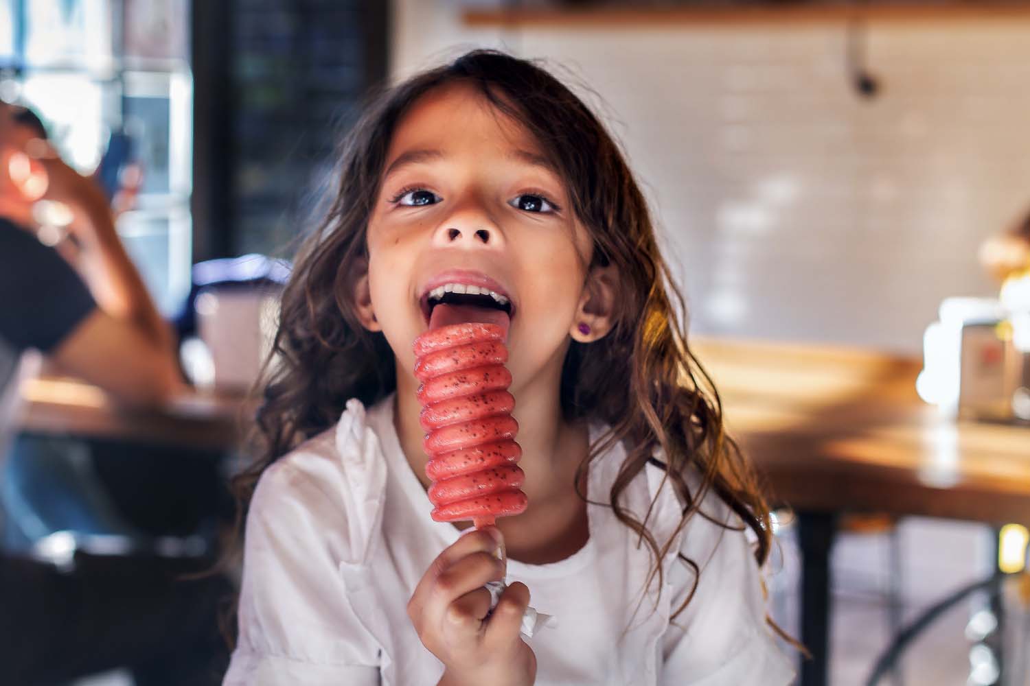 A girl licking an ice cream