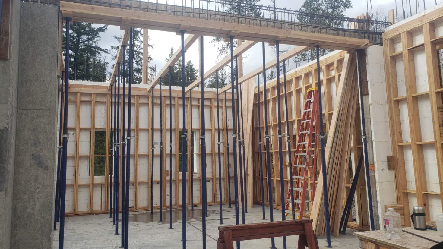 Steel props and timber beams supporting slab and beam formwork on site