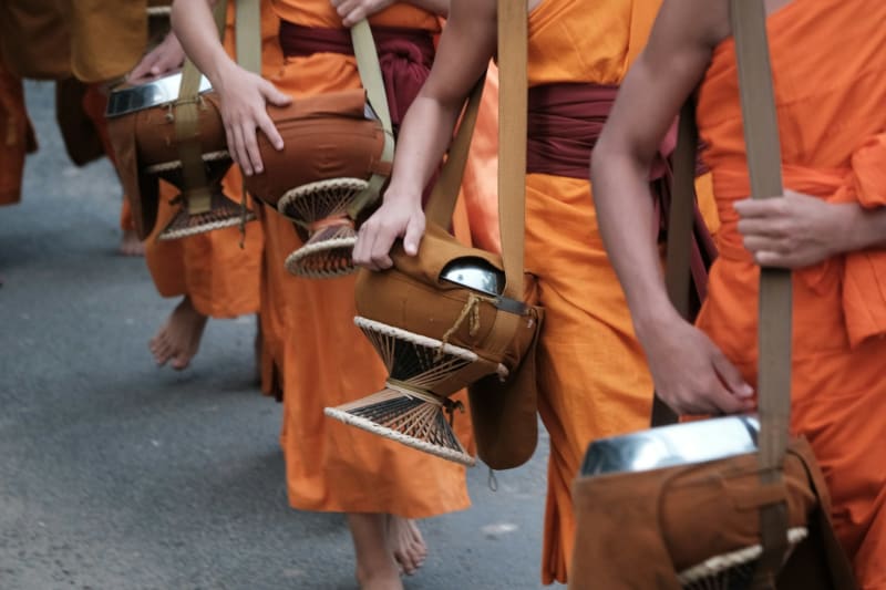 Dawn alms-giving procession of monks in Luang Prabang